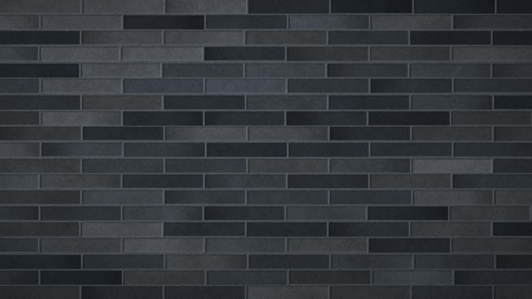 Long-format charcoal brick slips with dark joints
