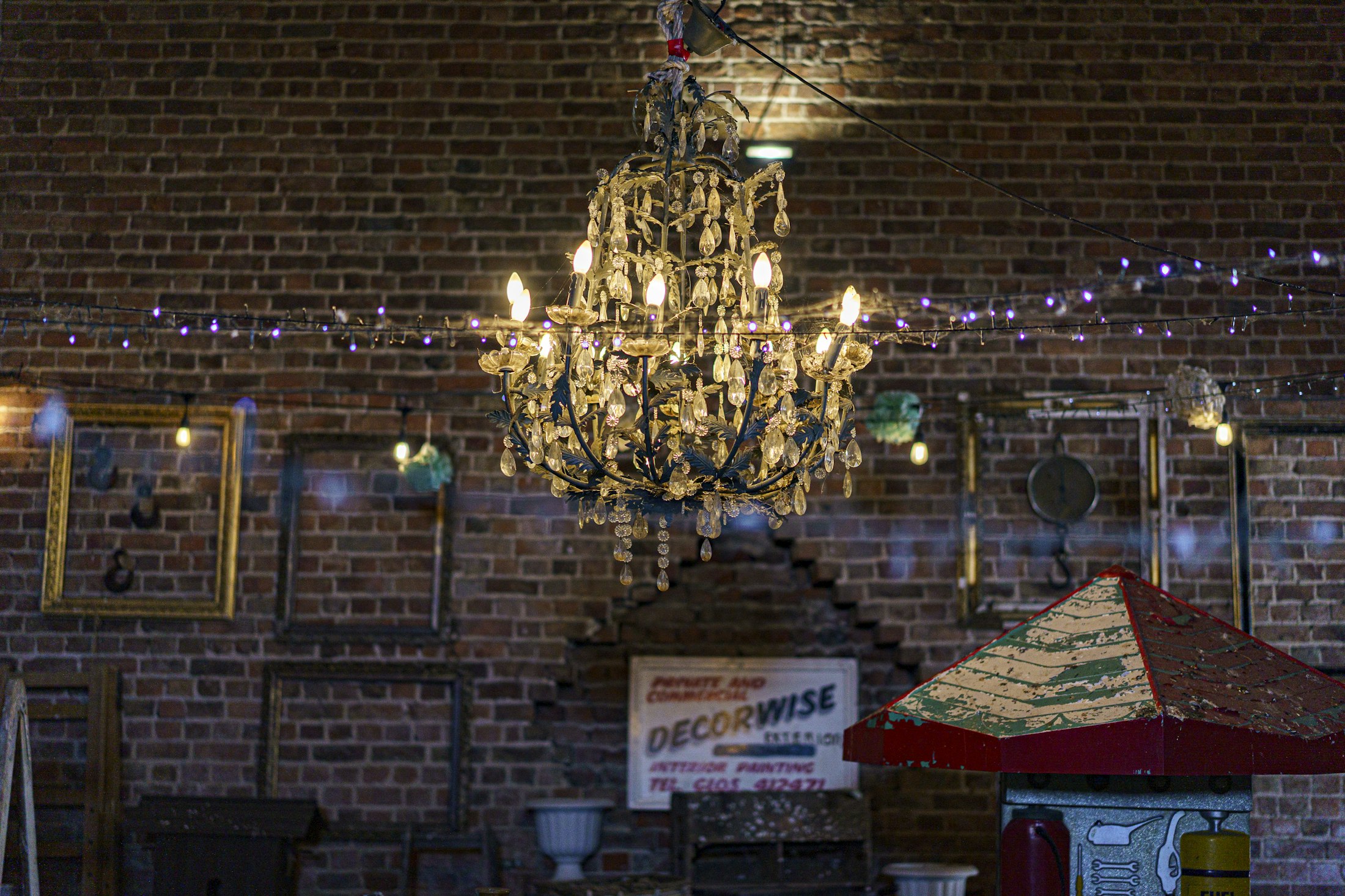 Crystal chandelier in front of a reclaimed brick wall